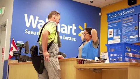 Motion of people returning goods at customer service counter Stock Footage 77329179