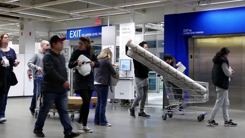 Motion of people taking elevator inside Ikea store with 4k resolution Video stock 73851589