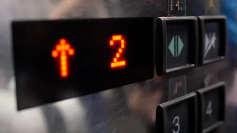 Motion of people taking the elevator from one to second floor inside a Stock Footage 280153998