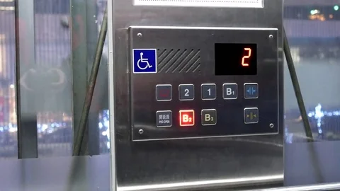 Motion of people taking elevator from two to B2 floor inside shopping mall Stock Footage 84711546