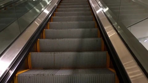 Motion of people taking escalator inside Forever 21 store Stock Footage 70930990