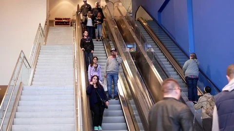Motion of people taking escalators in modern urban interior inside Walmart store Stock Footage 74976408