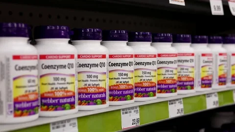 Motion of people taking Webber naturals Q10 inside Shoppers drug mart store Stock Footage 74475077