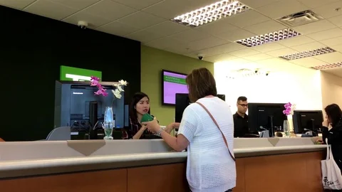 Motion of people talking to the teller inside TD Bank with 4k resolution Video stock 76111252