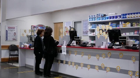 Motion of people waiting to pick up their medicine inside Costco pharmacy 스톡 동영상 79672944