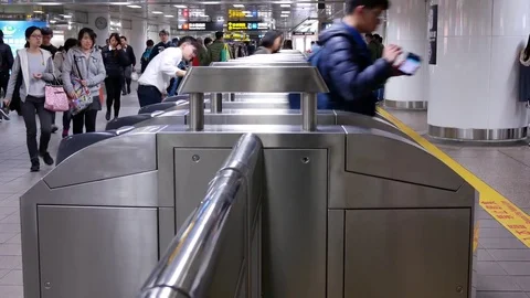 Motion of people walking through the fare pay zone and tapping their card for Stock Footage 84179670