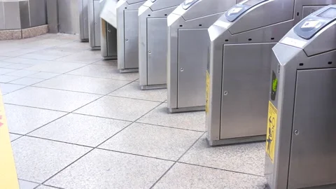 Motion of people walking through the fare pay zone and tapping their card Video stock 167346122