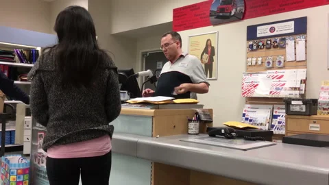 Motion of person mailing parcel at post office inside shopper drug mart Stock Footage 123043259
