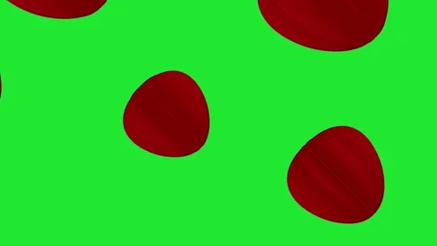 Motion red, seed-like 3D objects against a solid green background Stock Footage 321057110