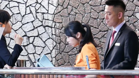 Motion of restaurant receptionist and manger waiting customer Stock Footage 97042787