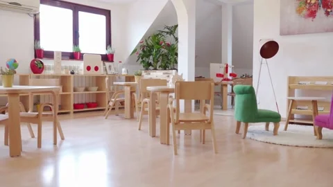 Motion to the right showing empty school classroom with chairs under desks. Stock Footage 256720008