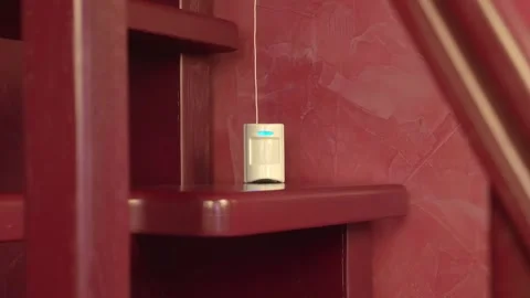 Motion sensor on which blue LED lights up, indicating the detection of movement Stock Footage 297780930