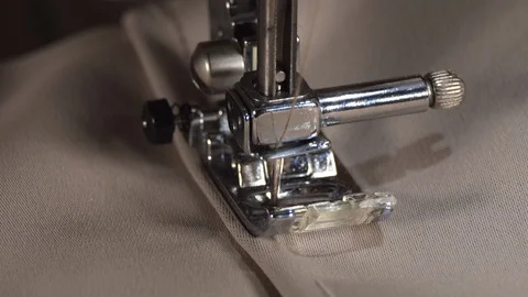 Motion of sewing machine needle, macro. Sewing fabric by sewing machine. 4K Stock Footage 129400072