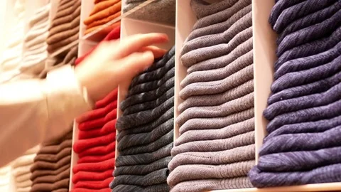 Motion of shopper buying socks at display socks cabinet inside uniqlo store Stock Footage 84862486
