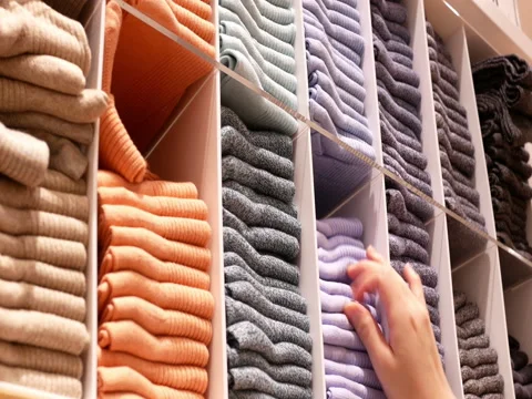 Motion of shopper buying socks at display socks cabinet inside uniqlo store 스톡 동영상 84864342