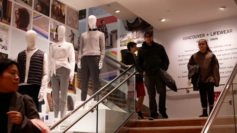 The motion of shopper walking and browsing at stairs inside Uniqlo store Video stock 172463108