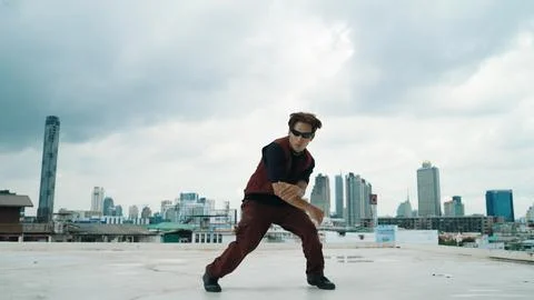 Motion shot of B-boy dance performance by professional street dancer. Endeavor. Stock Photos