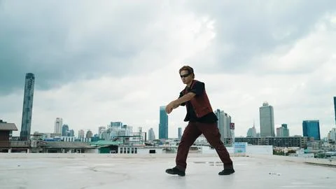 Motion shot of B-boy dance performance by professional street dancer. Endeavor. Stock Photos