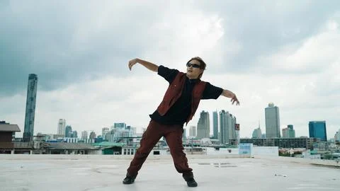 Motion shot of B-boy dance performance by professional street dancer. Endeavor. Stock Photos