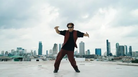 Motion shot of B-boy dance performance by professional street dancer. Endeavor. Stock Photos