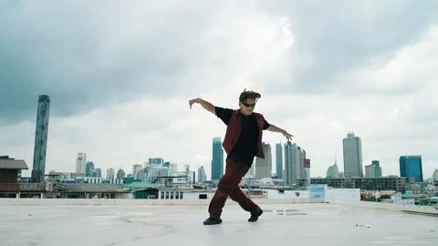 Motion shot of B-boy dance performance by professional street dancer. Endeavor. Stock Photos