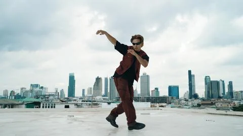 Motion shot of B-boy dance performance by professional street dancer. Endeavor. Stock Photos