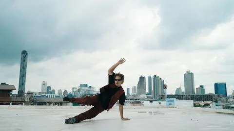 Motion shot of B-boy dance performance by professional street dancer. Endeavor. Stock Photos