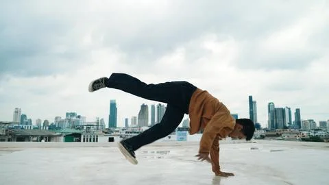 Motion shot of B-boy dance performance by professional street dancer. Endeavor. Stock Photos