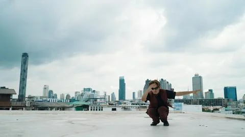 Motion shot of B-boy dance performance by professional street dancer. Endeavor. Stock Photos