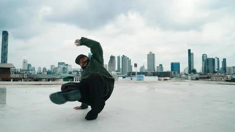 Motion shot of B-boy dance performance by professional street dancer. Endeavor. Stock Photos