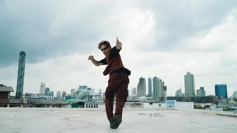 Motion shot of B-boy dance performance by professional street dancer. Endeavor. Stock Photos