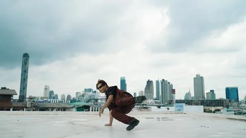 Motion shot of B-boy dance performance by professional street dancer. Endeavor. Stock Photos