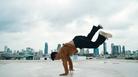 Motion shot of B-boy dance performance by professional street dancer. Endeavor. Stock Photos