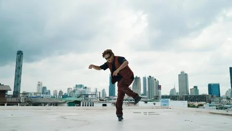 Motion shot of B-boy dance performance by professional street dancer. Endeavor. Stock Photos