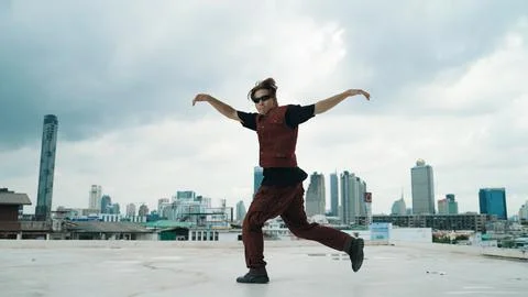 Motion shot of B-boy dance performance by professional street dancer. Endeavor. Stock Photos