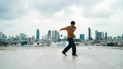 Motion shot of B-boy dance performance by professional street dancer. Hiphop. Stock Photos