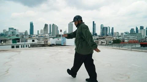 Motion shot of B-boy dance performance by professional street dancer. Hiphop. Stock Photos