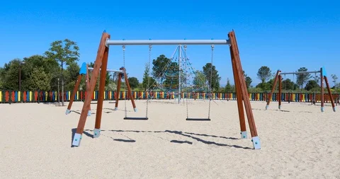 Motion shot of double empty swings in playground Stock Footage 101471200
