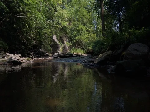 Motion shot over flowing stream with small waterfalls Video stock 77167586