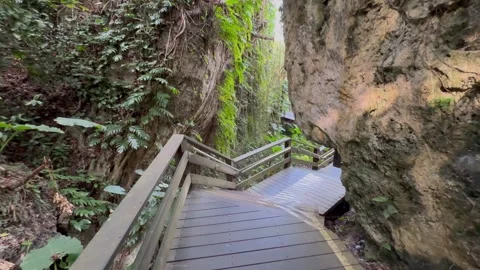 Motion shot of walking through limestone cave, handheld, 4k. Stock Footage 270072846
