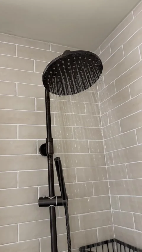 Motion Shot of Water Falling From Shower Head Close-up of turning on water spray Stock Footage 262543527