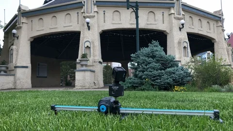 Motion slider time lapse pan camera in action in park 動画素材 93573653