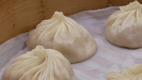 Motion of  soup dumpling buns with steam inside Chinese restaurant Stock Footage 83693232