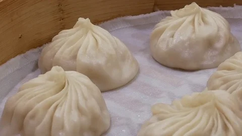 Motion of  soup dumpling buns with steam inside Chinese restaurant Stock Footage 83695458