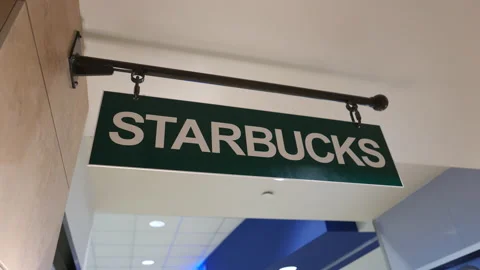 Motion of Starbucks sign on wall inside mall with 4k resolution. Stock Footage 208340387
