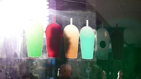 Motion of sunlight shining from outside window on colorful cups sign Stock Footage 78037710