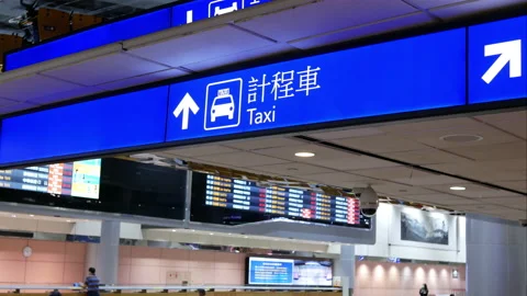 Motion of taxi direction sign inside Taoyuan international airport Stock Footage 98562743