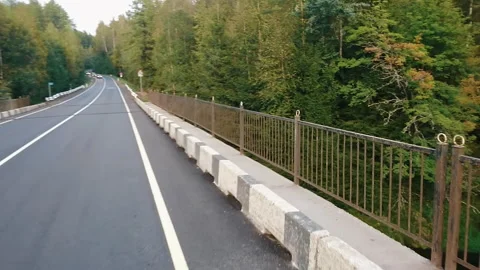 Motion through nature outdoors. On the road past the river Video stock 259726331