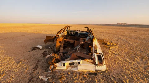 Motion time lapse of abandoned car in the desert sand dune Stock Footage 242235794