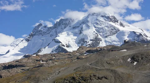 Motion time lapse cloud vortices on snow covered Peaks  Swiss Italian Alps Stock Footage 32328005